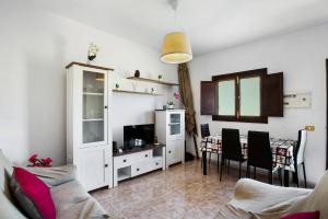a living room with a couch and a dining room at Villa Palomino in Gáldar