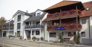 a building with flower boxes on the balconies at Deluxe Ferienwohnungen Diana in Radolfzell am Bodensee