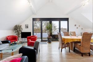 a living room with a table and chairs at Deluxe Ferienwohnungen Diana in Radolfzell am Bodensee