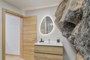 a bathroom with a sink and a stone wall at Casas de Vacaciones Ibaiale in Cazadores +68 photos