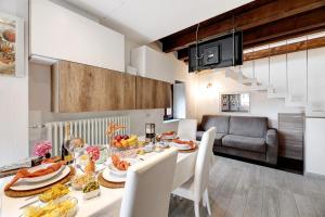 a kitchen and dining room with a table with food at La Sosta di Isa in Delebio +17 photos