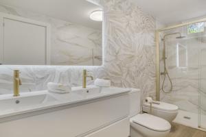 a white bathroom with a sink and a toilet at Las Mimosas Ronda in Ronda +22 photos