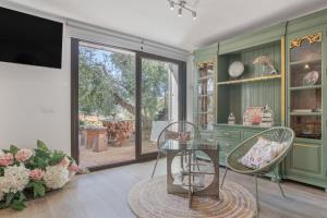 a living room with a glass table and chairs at Las Mimosas Ronda in Ronda