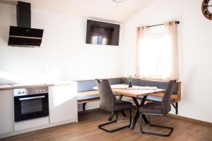 a kitchen with a table and chairs in a room at Kleines Glück Wettenberg in Hochdorf +15 photos