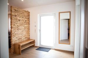a room with a brick wall and a mirror at Kleines Glück Wettenberg in Hochdorf