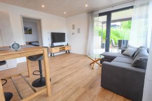 a living room with a couch and a table at Ferienwohnung Talblick in Kappelrodeck