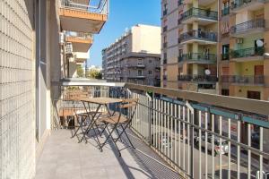 a balcony with a table and chairs and some buildings at Il Centro Luxury Suites in Bari