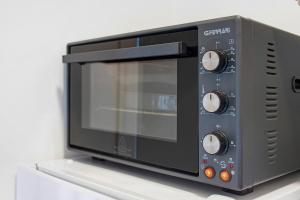 a microwave oven sitting on top of a shelf at Il Centro Luxury Suites in Bari