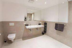a bathroom with a sink and a toilet at Alpenblick De Luxe in Oetz +30 photos