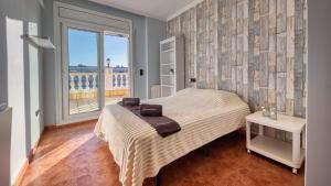 a bedroom with a bed and a large window at Costacabana - Villa Summertime in Lloret de Mar +27 photos
