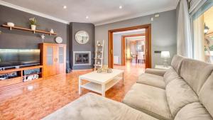 a living room with a couch and a table at Costacabana - Villa Summertime in Lloret de Mar