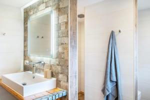 a bathroom with a sink and a mirror at Landhaus Gerda in Wangerland +23 photos