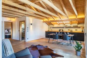 a living room with a couch and a table at Alpview Loft Garmisch in Garmisch-Partenkirchen +25 photos