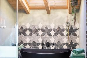 a bathroom with a black tub in a room at Alpview Loft Garmisch in Garmisch-Partenkirchen