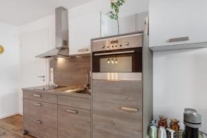 a kitchen with a sink and a stove at Casa Simona in Orsingen-Nenzingen