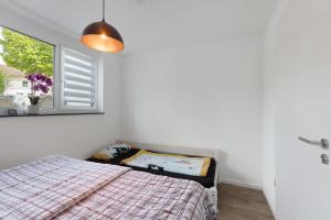 a bedroom with a bed and a window at Casa Simona in Orsingen-Nenzingen