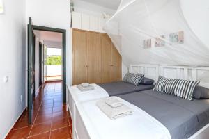 a bedroom with two beds in a room at Maison Menorca in Arenal d'en Castell