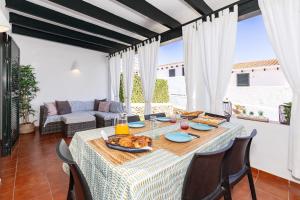 a dining room with a table with food on it at Maison Menorca in Arenal d'en Castell