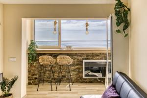 a living room with a fireplace and a window at Atic Moon Miami in Empuriabrava