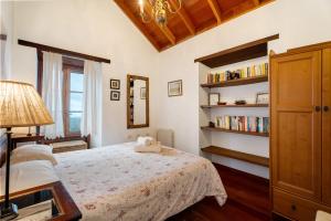 a bedroom with a bed and a book shelf at Casa Rural La Era in Valverde