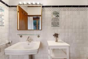 a white bathroom with a sink and a mirror at Casa Rural La Era in Valverde +22 photos
