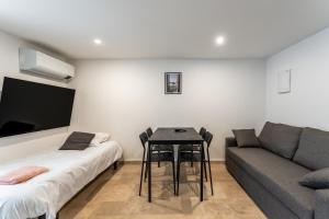 a living room with a table and a couch at Canto Cigalo Duplex 12 in Robion en Luberon