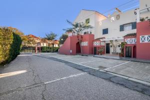 an empty street with red and white buildings at Duplex Islantilla Golf in Huelva