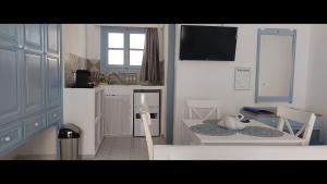 a small kitchen with a table and chairs in a room at Pico Bello Patmos 26 in Patmos
