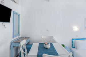 a living room with a table and a couch at Pico Bello Patmos 26 in Patmos