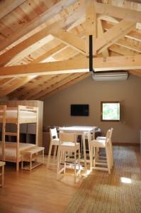 a room with a table and chairs and a bunk bed at El Albergue Rural in Mombeltrán