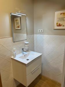 a bathroom with a sink and a mirror at El Albergue Rural in Mombeltrán +27 photos