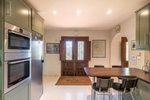 a kitchen with a wooden table and some chairs at La Casa 1950 in Montefrío