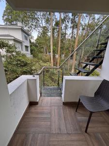 a staircase with a chair and a stair case at Silver Breeze in Yercaud