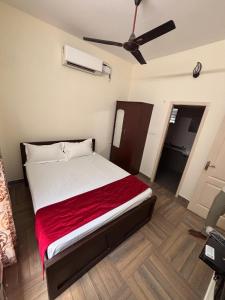 a bedroom with a bed and a ceiling fan at Silver Breeze in Yercaud