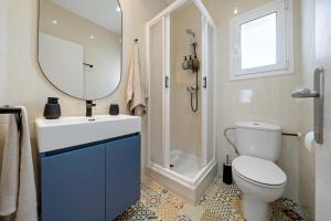 a bathroom with a toilet and a sink and a mirror at The Sunset Calafell in Calafell +12 photos