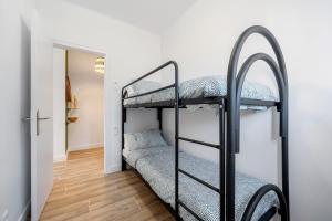 a room with two bunk beds and a hallway at The Sunset Calafell in Calafell