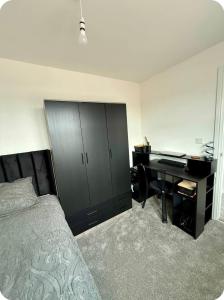 a bedroom with a desk and a bed and a deskictericter at Single room in Tamworth in Wigginton