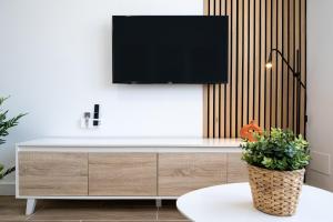 a tv on top of a dresser in a living room at The Sunset Calafell in Calafell
