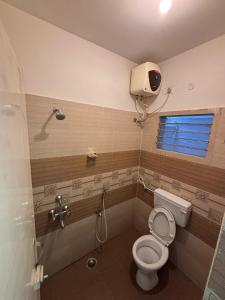 a bathroom with a toilet and a shower at Silver Breeze in Yercaud +7 photos