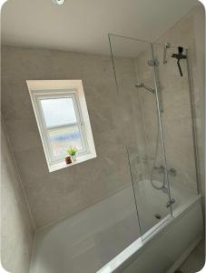 a bathroom with a shower and a window at Single room in Tamworth in Wigginton