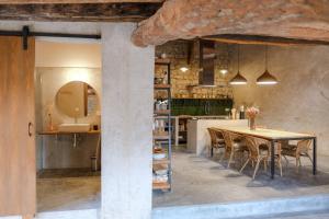 a kitchen and dining room with a table and chairs at Casa Comalats in Montoliu de Segarra