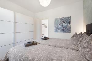 a bedroom with a bed with two slippers on it at Casa Agua Y Sol I in Poris de Abona +19 photos