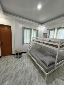 a bedroom with two bunk beds in a room at Yena's Inn in Cauayan