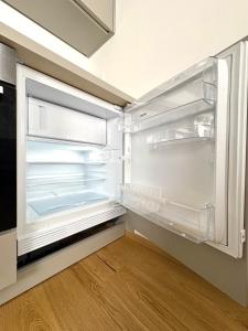 an empty refrigerator with its door open in a kitchen at Am See 18 in Podersdorf am See