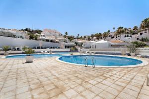 a swimming pool in front of a villa at Holiday Valley Blue Ocean B2 in Adeje