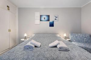 a bedroom with a bed with two towels on it at Holiday Valley Blue Ocean B2 in Adeje +18 photos