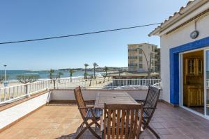 a table and chairs on a balcony with the beach at Mimosa in L'Escala