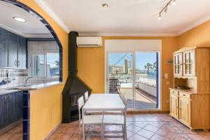 a kitchen with a table and a view of the ocean at Mimosa in L'Escala