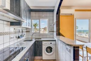 a kitchen with a washer and dryer at Mimosa in L'Escala