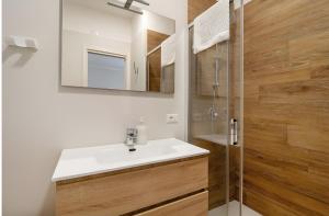 a bathroom with a white sink and a shower at Il Centro Luxury Suites in Bari +65 photos